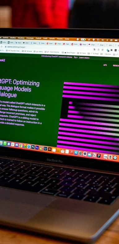 ChatGPT on a Laptop Laptop displaying a website with green background and purple striped graphics.