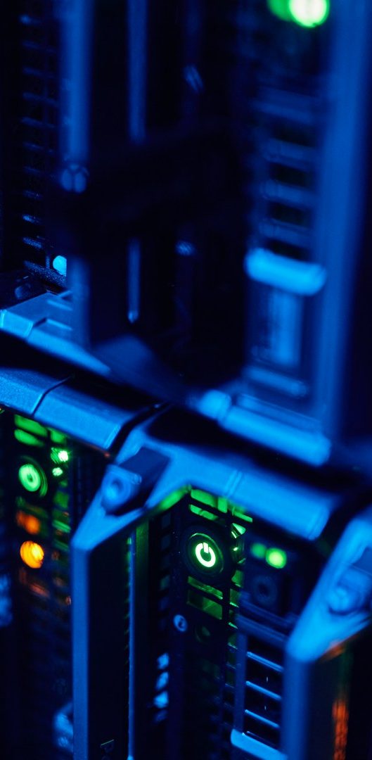 Picture of server rack for context Close-up of server racks with blue and green lights.